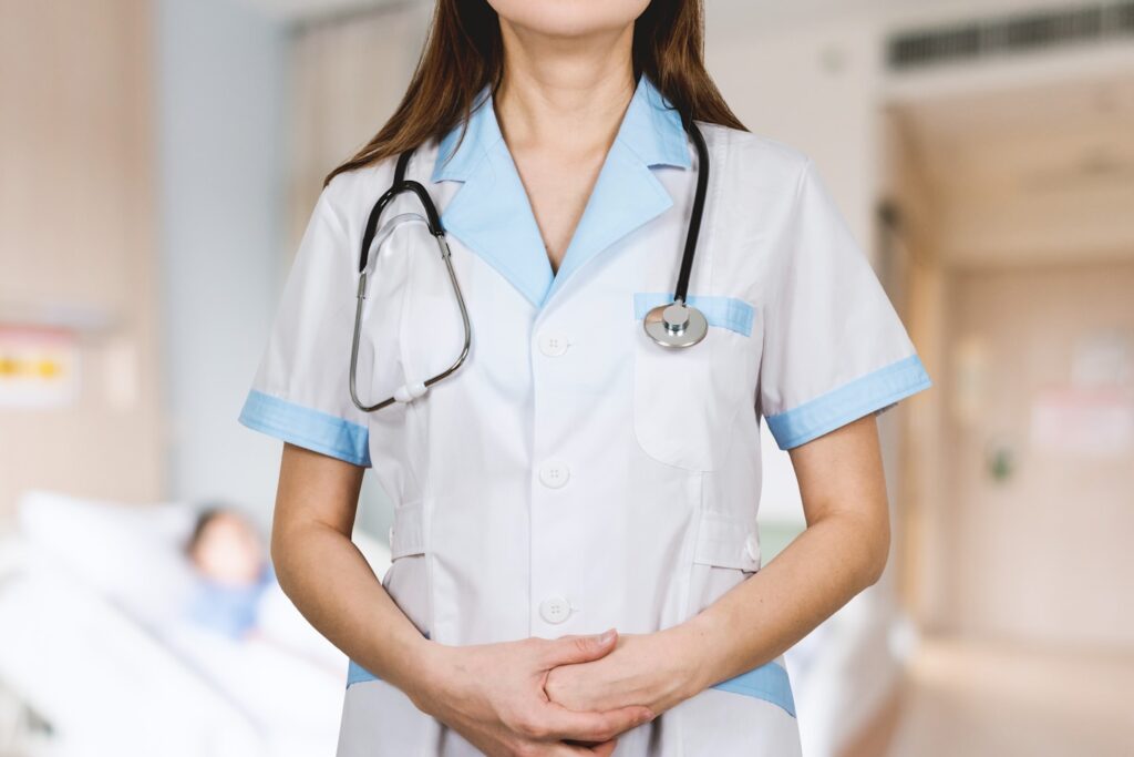 Detail of stethoscope. Doctor woman with white coat and stethoscope.